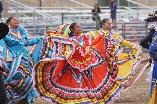 Women dancing in traditional dresses.